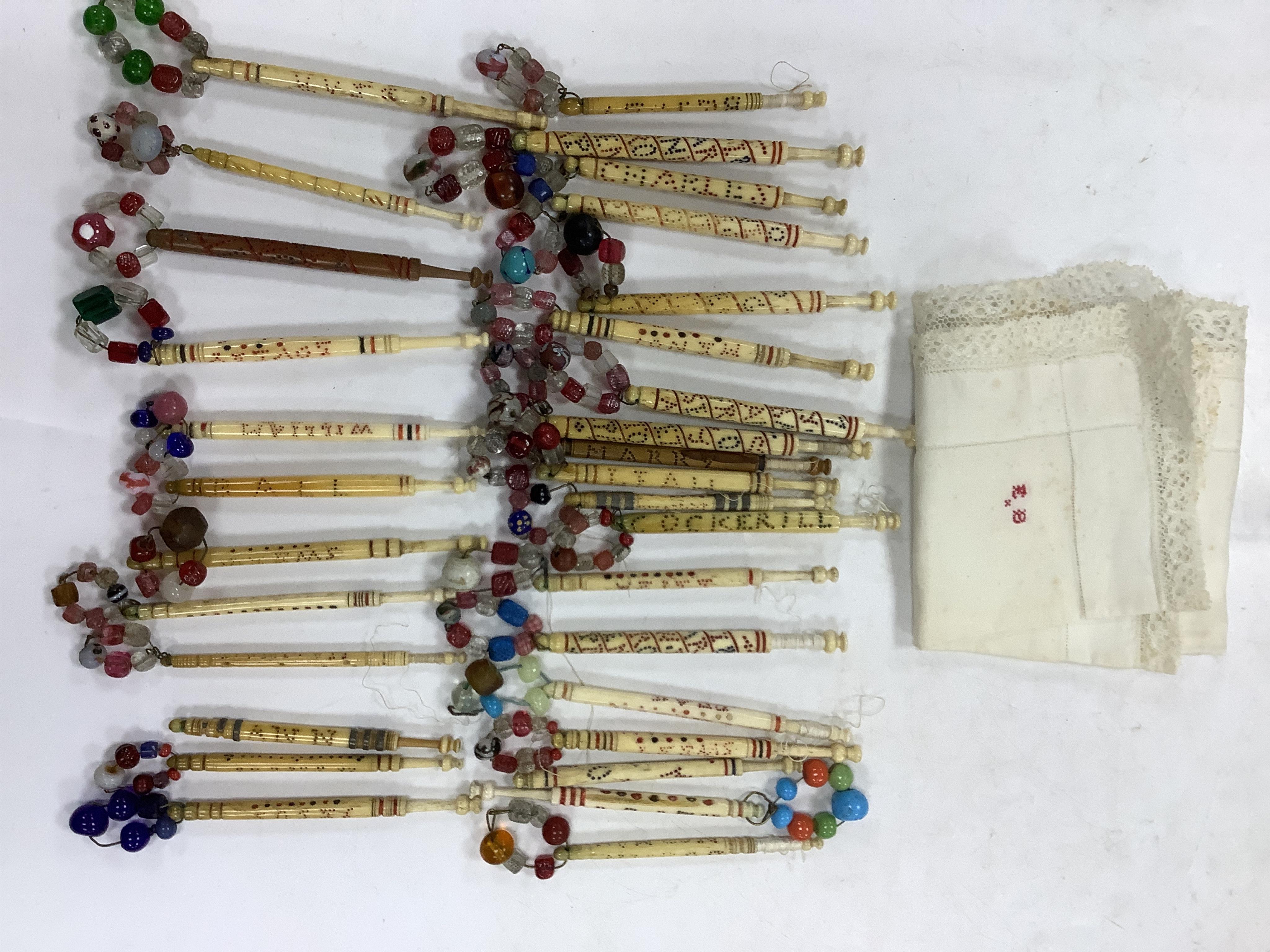 A collection of 19th century named and motto bone lace bobbins, including three named Barry bobbins with a related EB red embroidered monogram to lace edged hankie.(31 bobbins) Condition- light rust staining to hankie, b